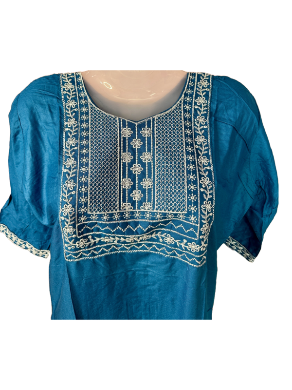 a blue and white embroidered shirt